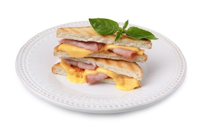 Pieces of toasted bread with melted cheese, ham and basil isolated on white