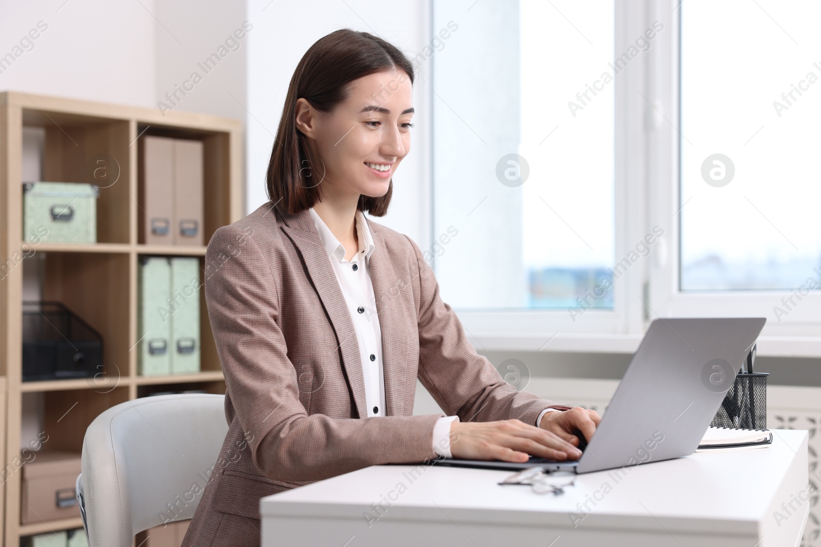 Photo of Woman with good posture working in office