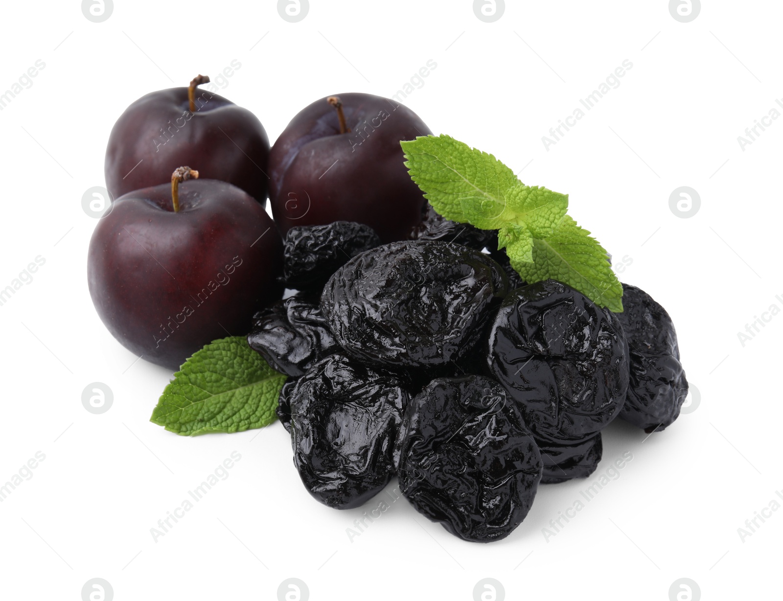 Photo of Delicious prunes, fresh ripe plums and mint isolated on white