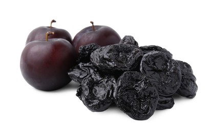 Delicious prunes and fresh ripe plums isolated on white