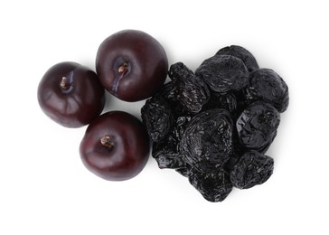 Delicious prunes and fresh ripe plums isolated on white, top view