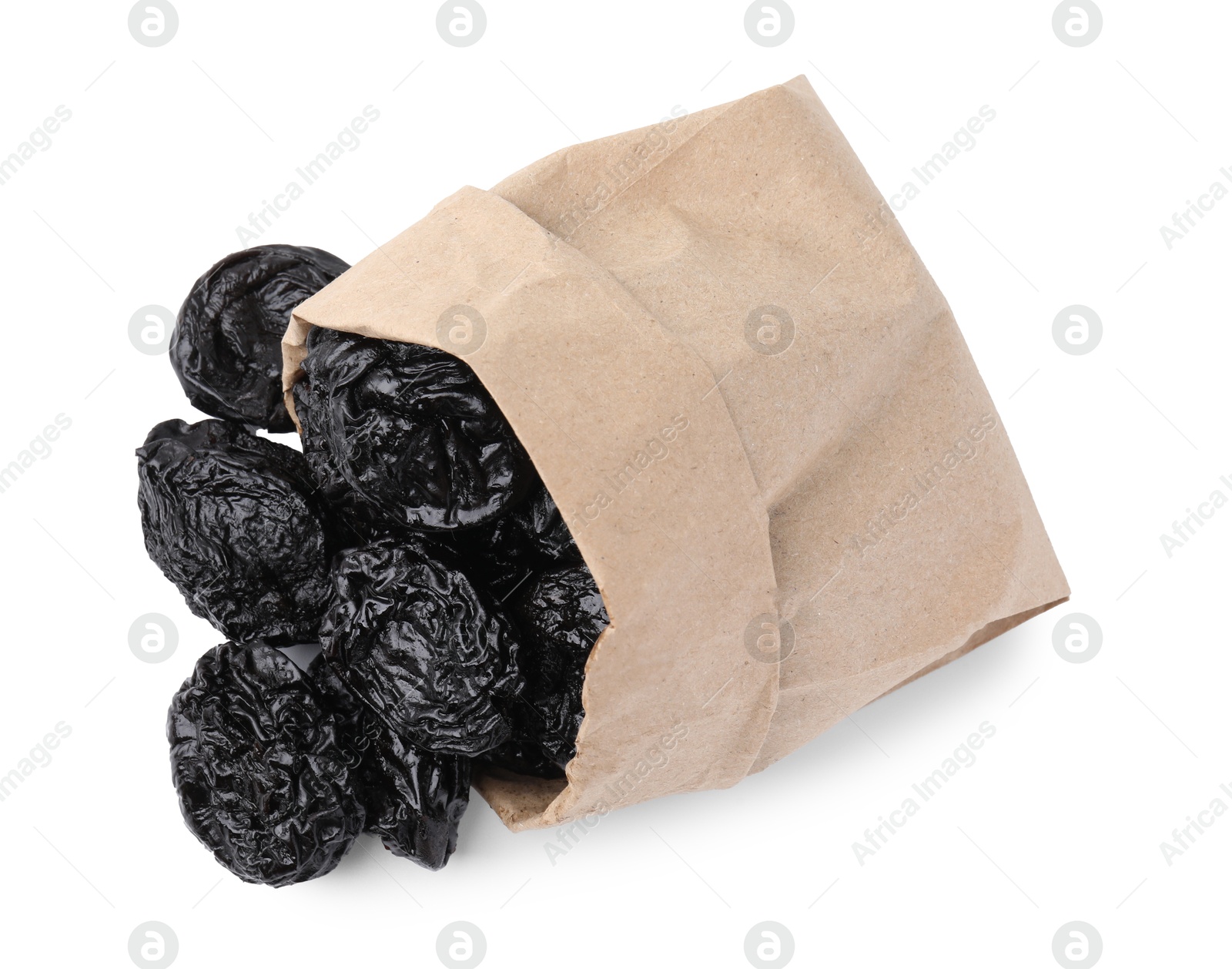 Photo of Paper bag with tasty dried plums (prunes) isolated on white, top view