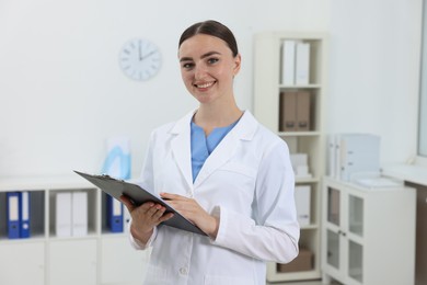 Photo of Professional receptionist with clipboard working in hospital