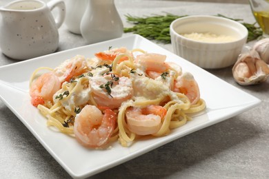 Photo of Delicious pasta with shrimps served on light table, closeup