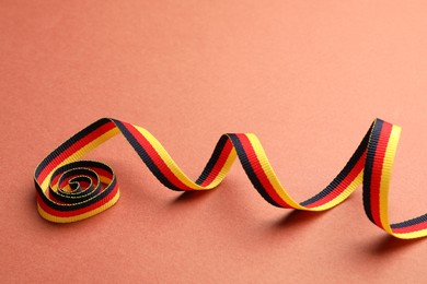 Ribbon in colors of German flag on color background