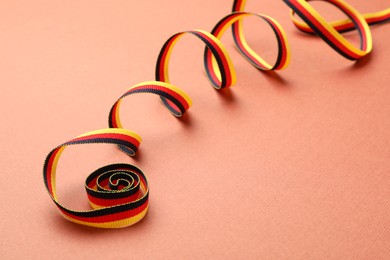 Photo of Ribbon in colors of German flag on color background