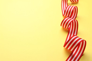 Striped ribbon on yellow background. Space for text