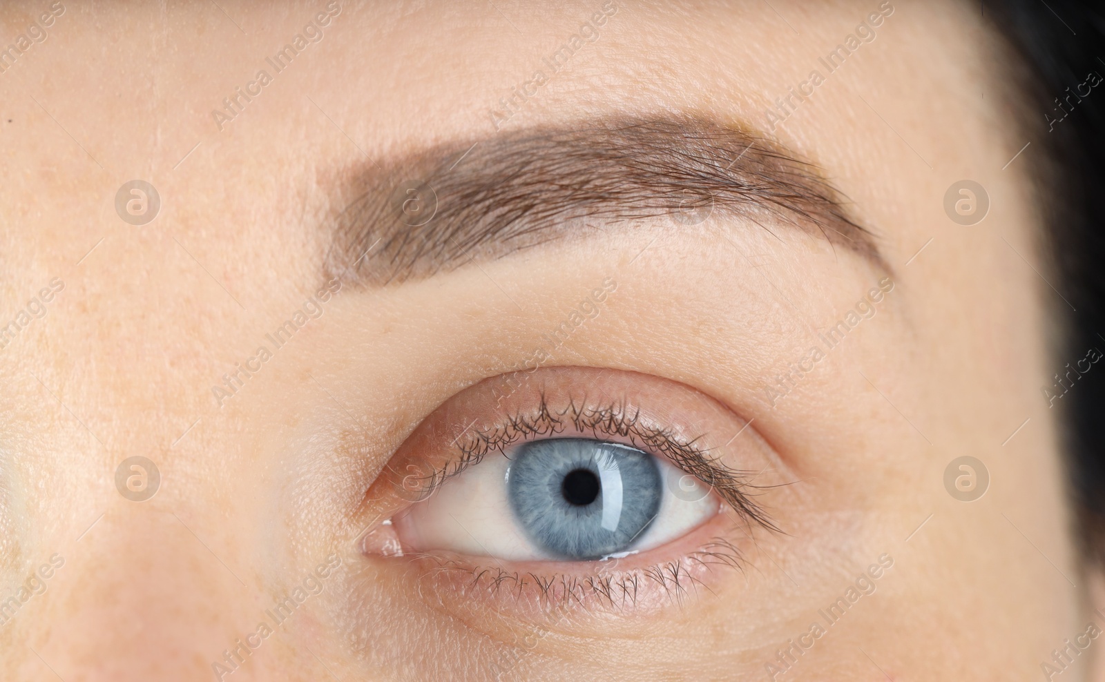 Photo of Woman with beautiful blue eyes, macro photo