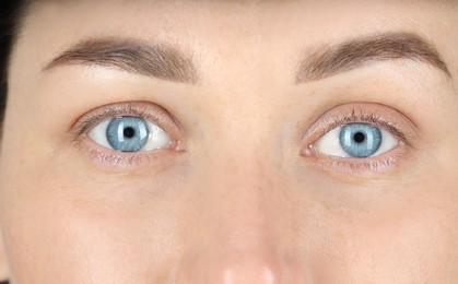 Photo of Woman with beautiful blue eyes, closeup view