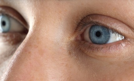 Photo of Woman with beautiful blue eyes, macro photo