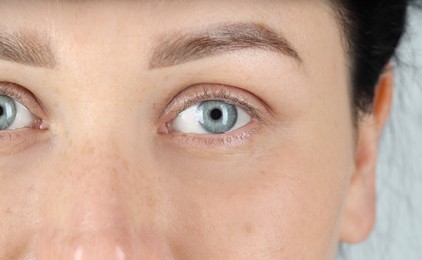 Photo of Woman with beautiful blue eyes, closeup view