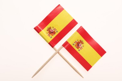 Small paper flags of Spain isolated on white