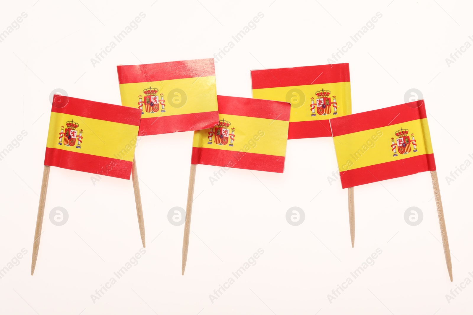 Photo of Small paper flags of Spain isolated on white