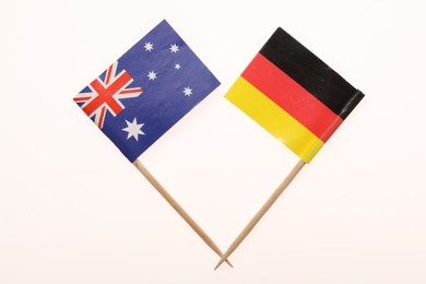 Photo of Small paper flags of Germany and Australia isolated on white