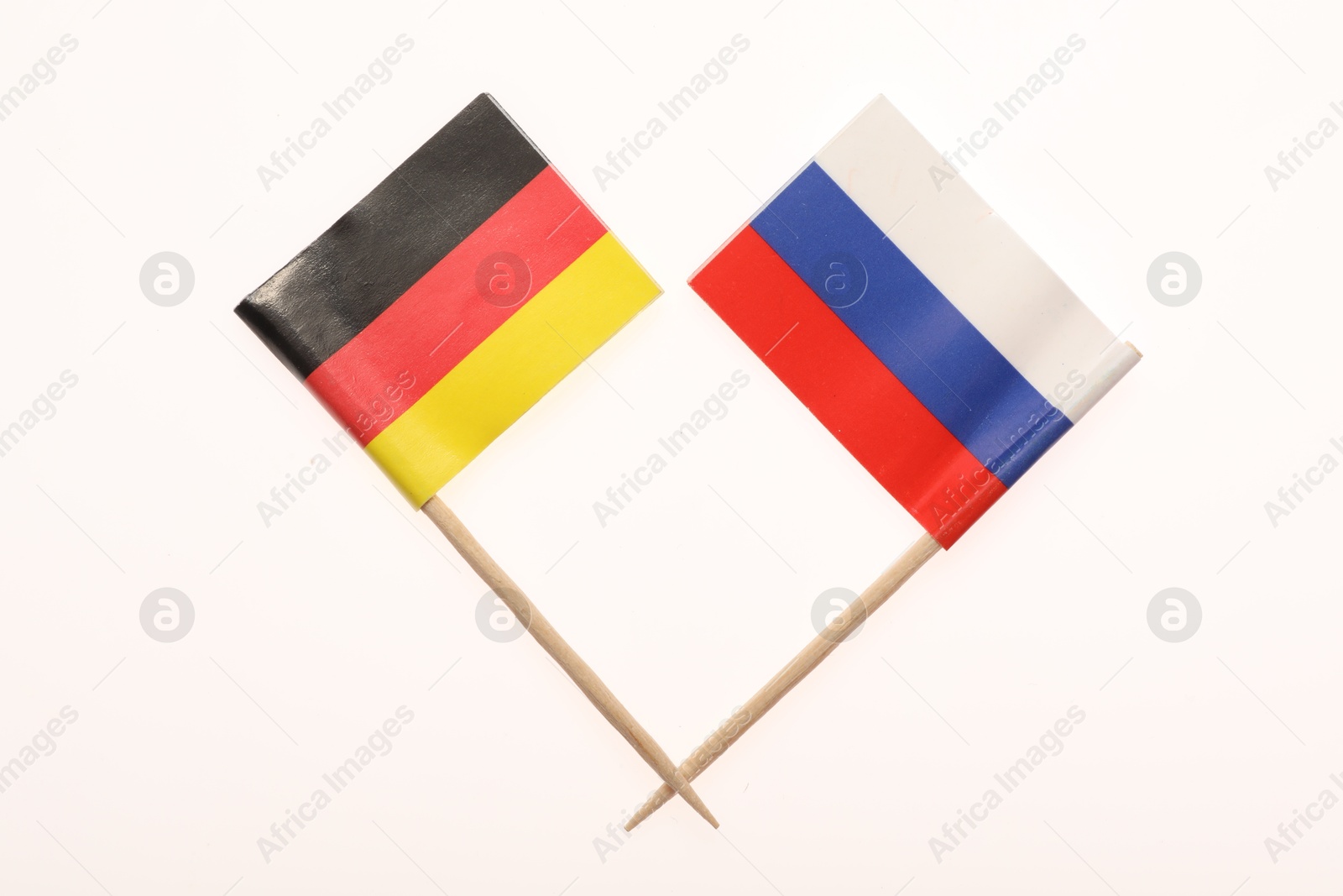 Photo of Small paper flags of Russia and Germany isolated on white