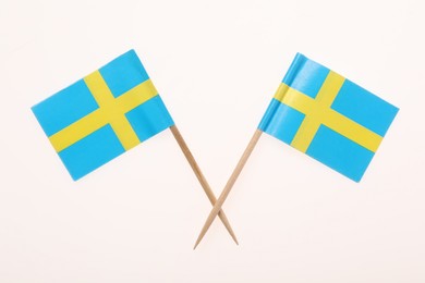 Small paper flags of Sweden isolated on white