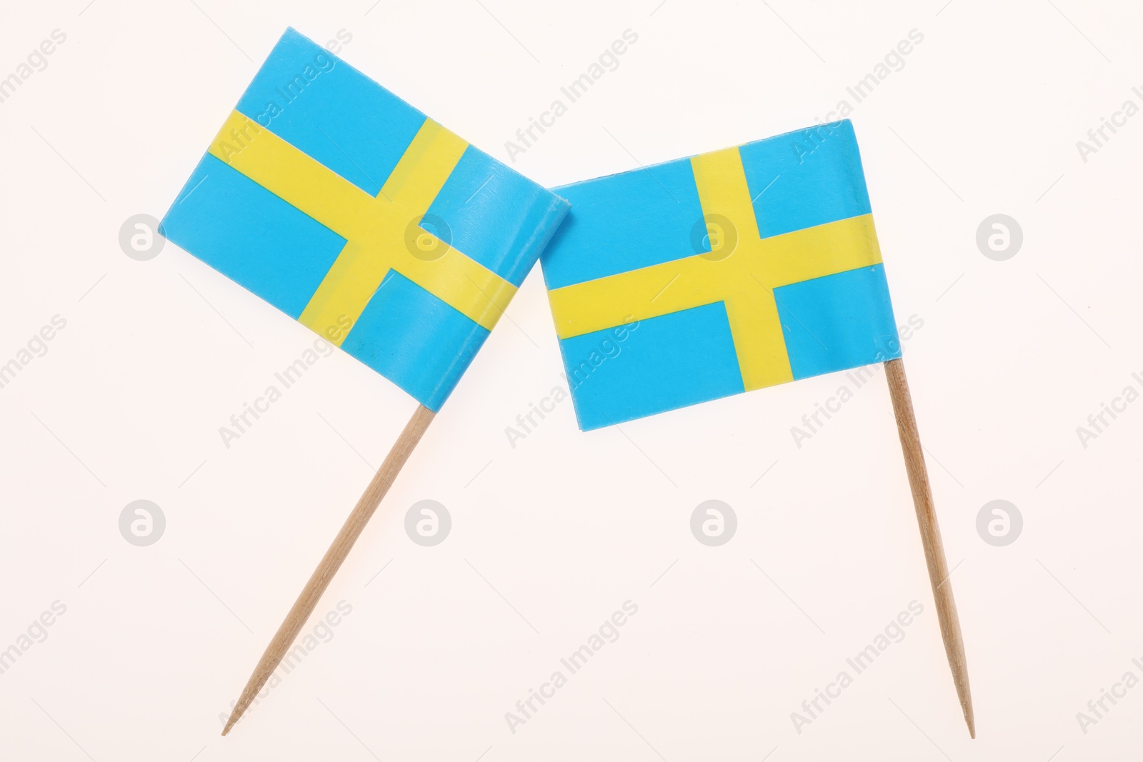 Photo of Small paper flags of Sweden isolated on white