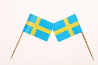 Small paper flags of Sweden isolated on white