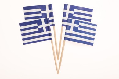 Small paper flags of Greece isolated on white