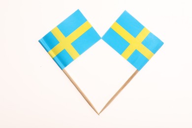 Photo of Small paper flags of Sweden isolated on white