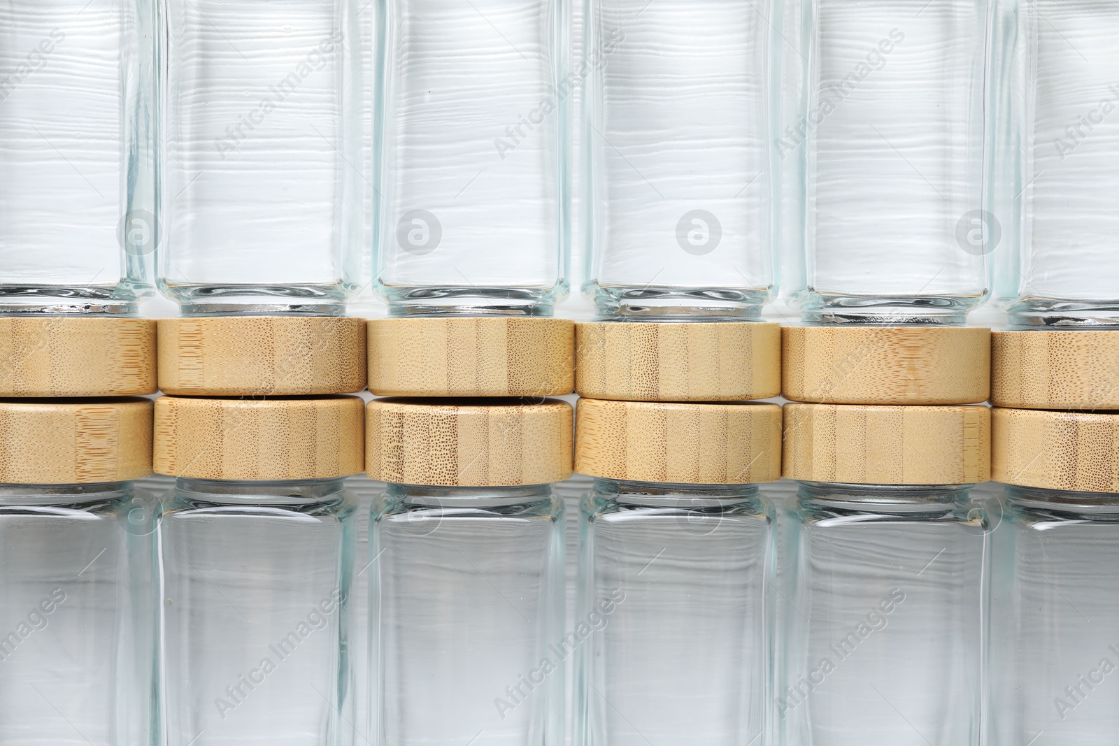 Photo of Empty glass jars on white wooden table, top view