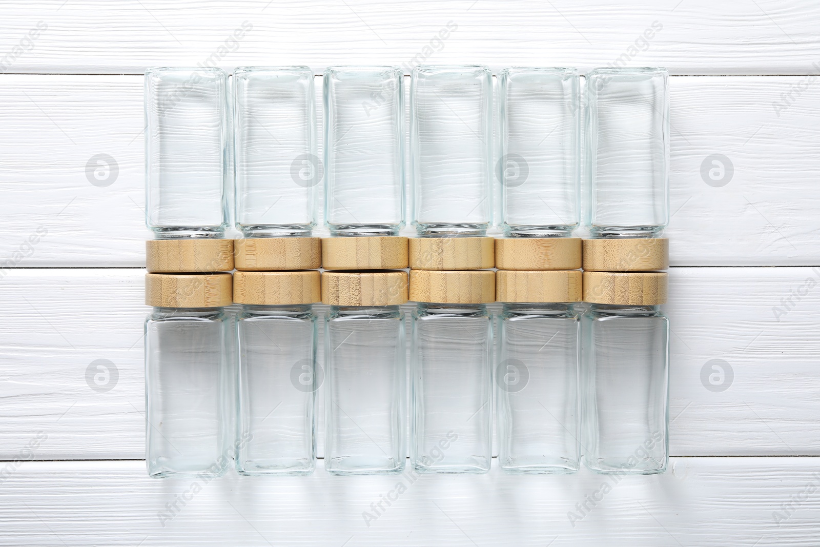 Photo of Empty glass jars on white wooden table, top view