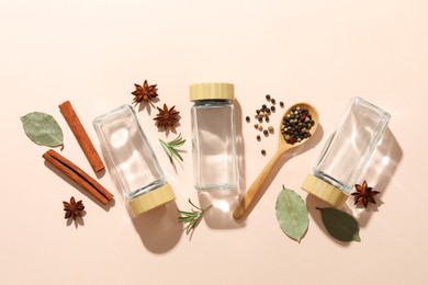 Photo of Different spices and glass jars on beige background, flat lay