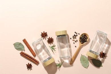 Photo of Different spices and glass jars on beige background, flat lay