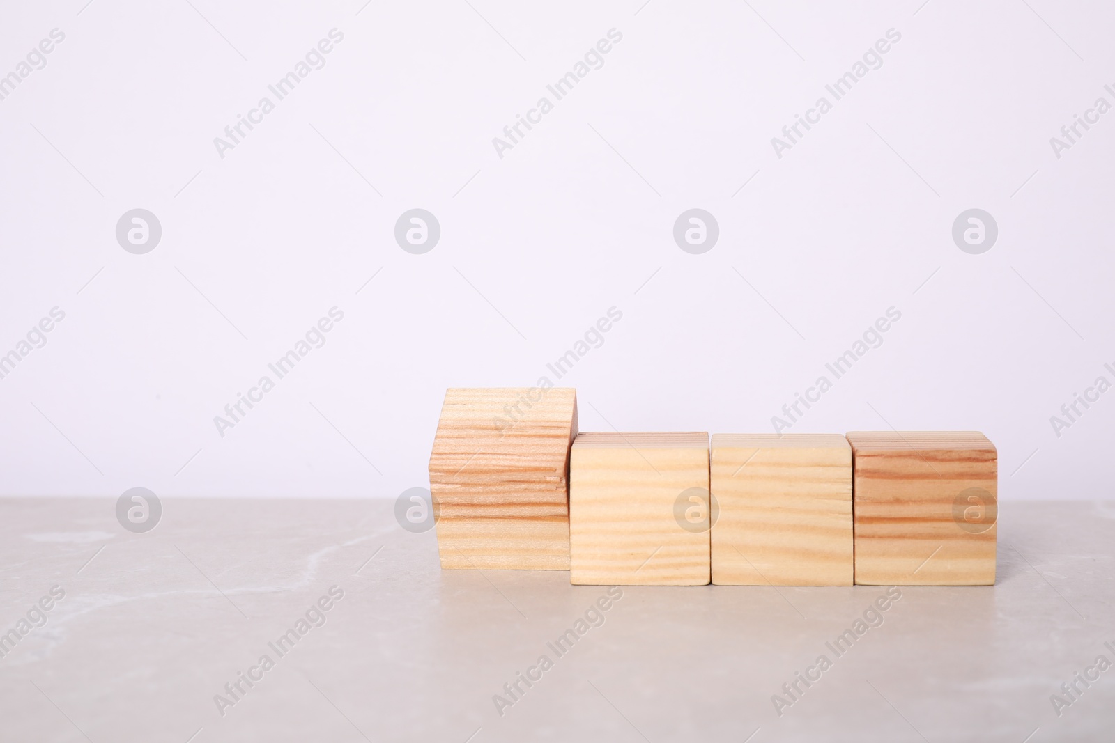 Photo of Wooden cubes on light table against white background. Space for text