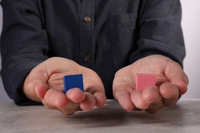 Photo of Woman with colorful cubes at light table, closeup