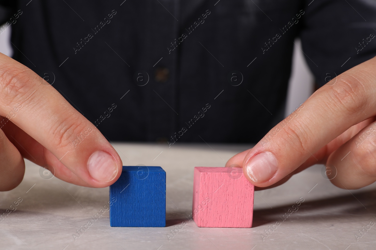 Photo of Woman with colorful cubes at light table, closeup