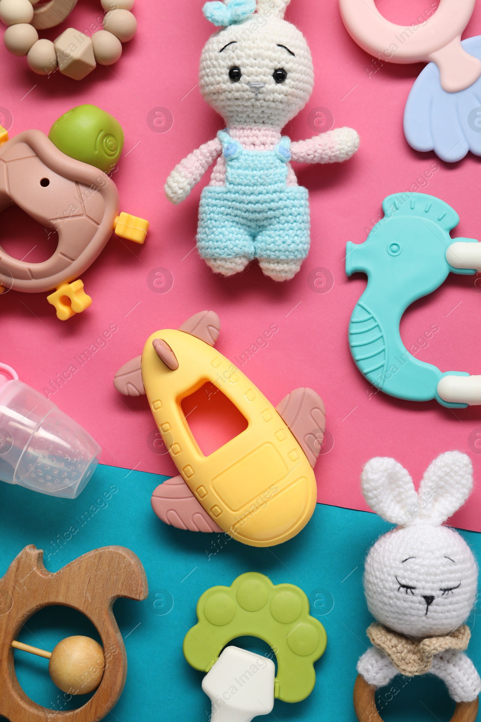 Photo of Different baby rattles on color background, flat lay