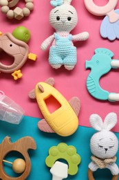 Different baby rattles on color background, flat lay