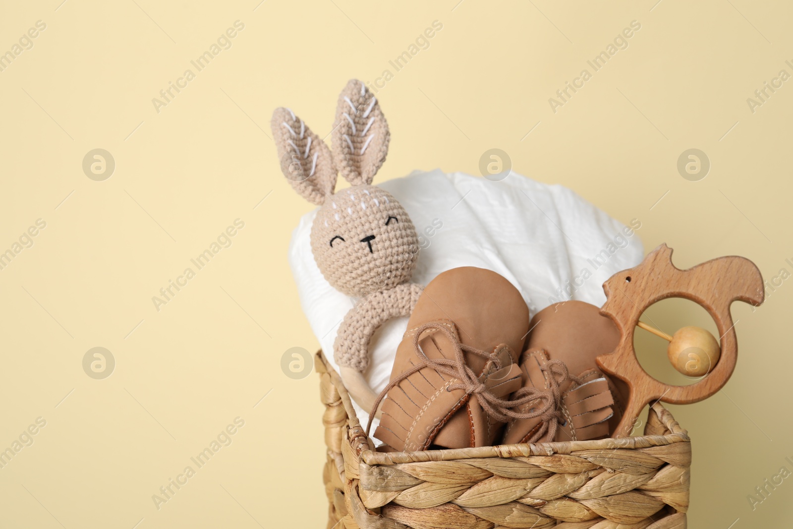 Photo of Baby accessories in box on beige background, closeup