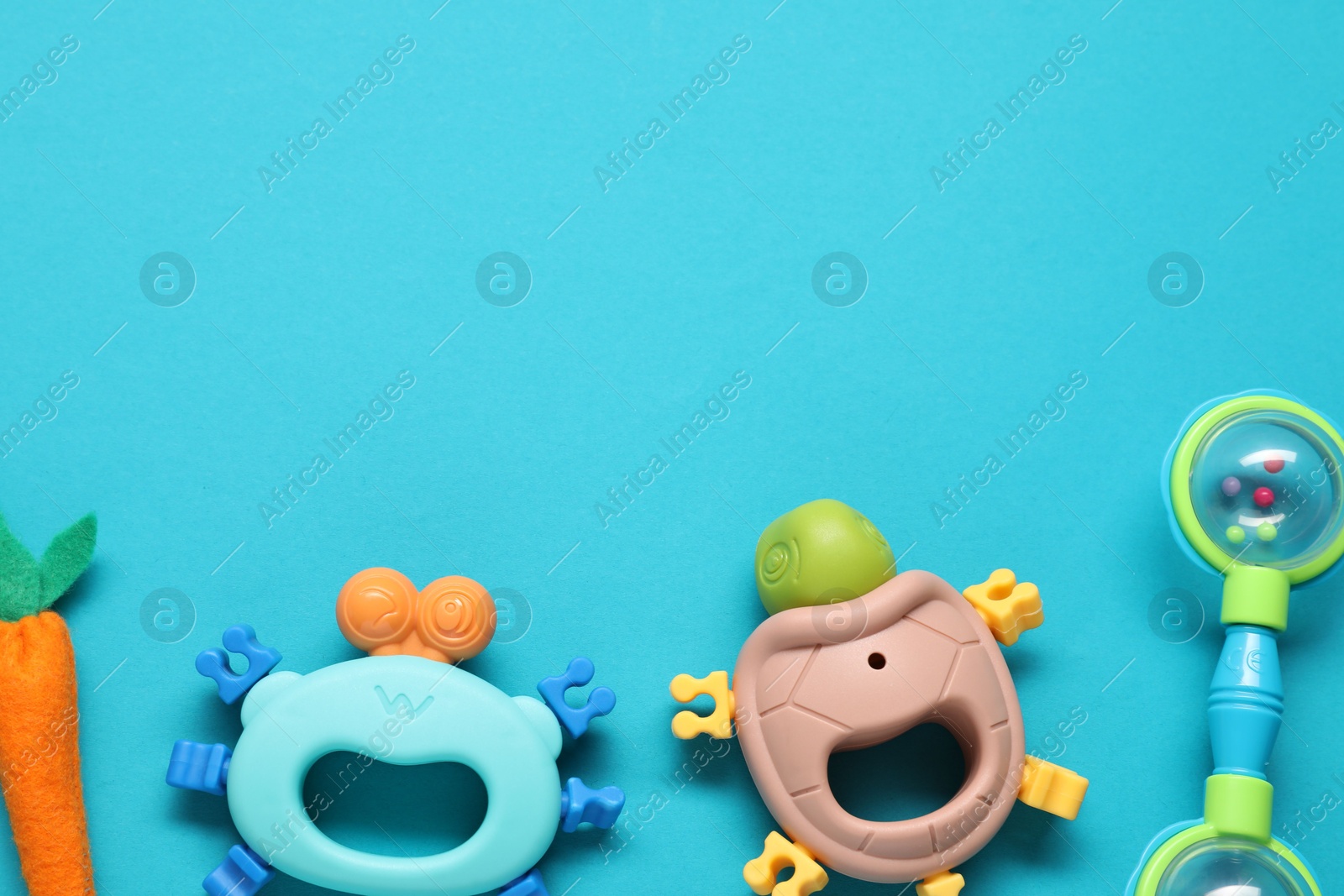 Photo of Different baby rattles on light blue background, flat lay. Space for text