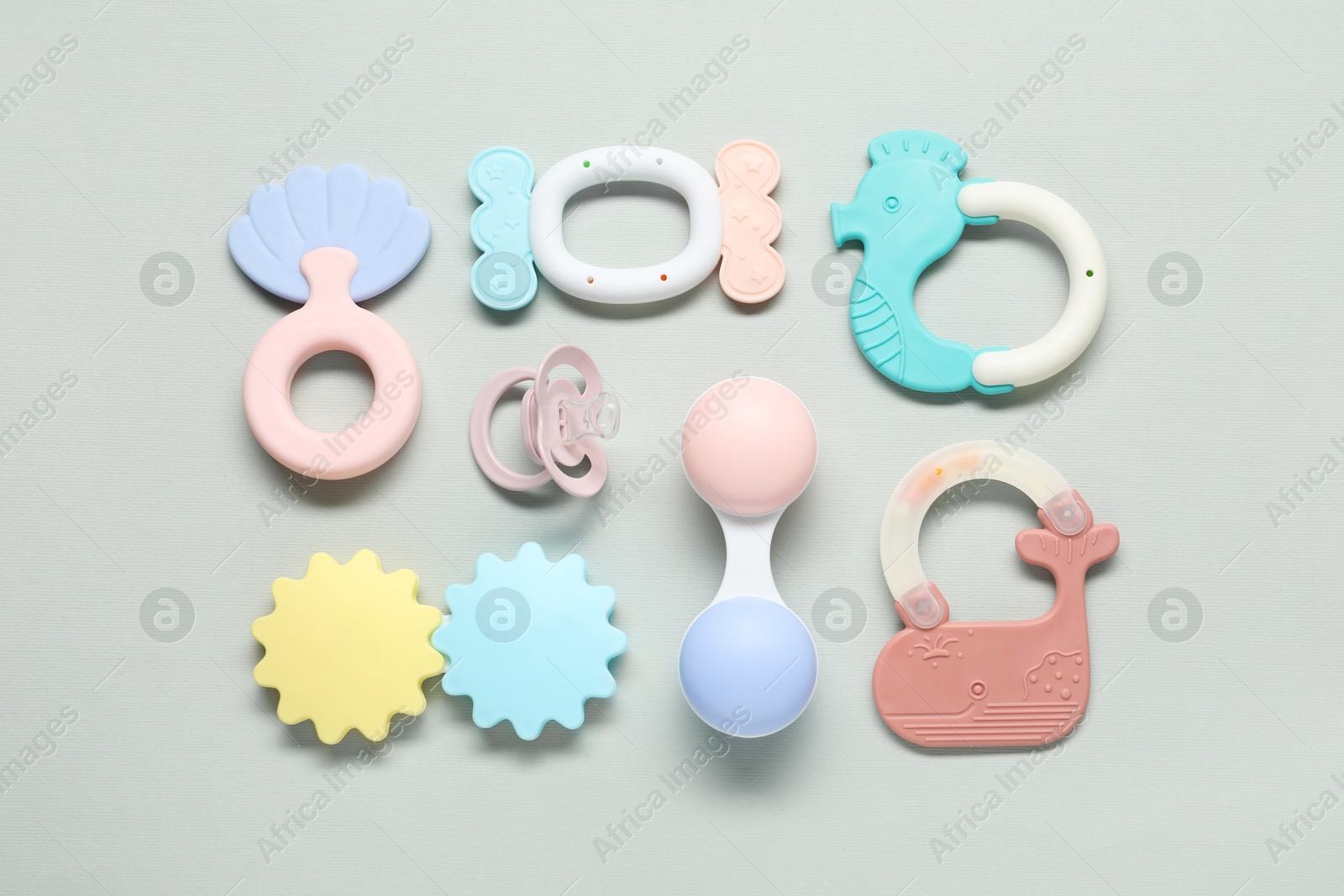 Photo of Different baby rattles on light background, flat lay