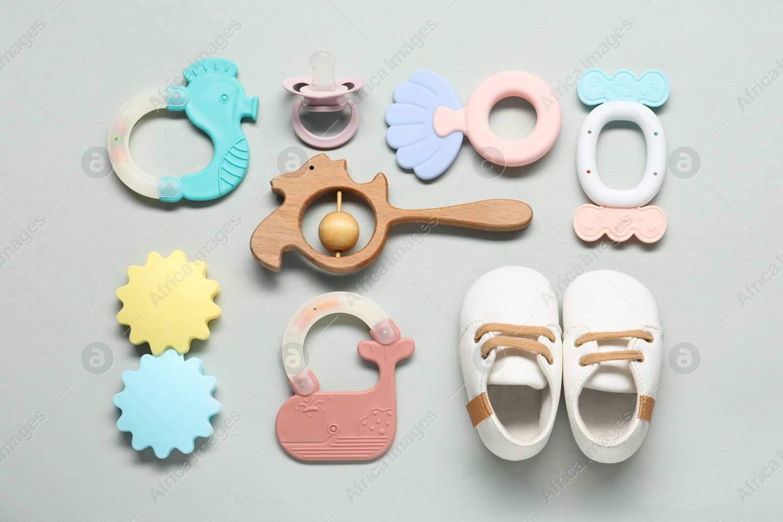 Photo of Different baby rattles on light background, flat lay