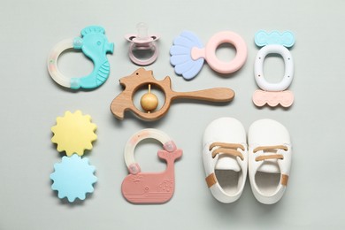 Different baby rattles on light background, flat lay