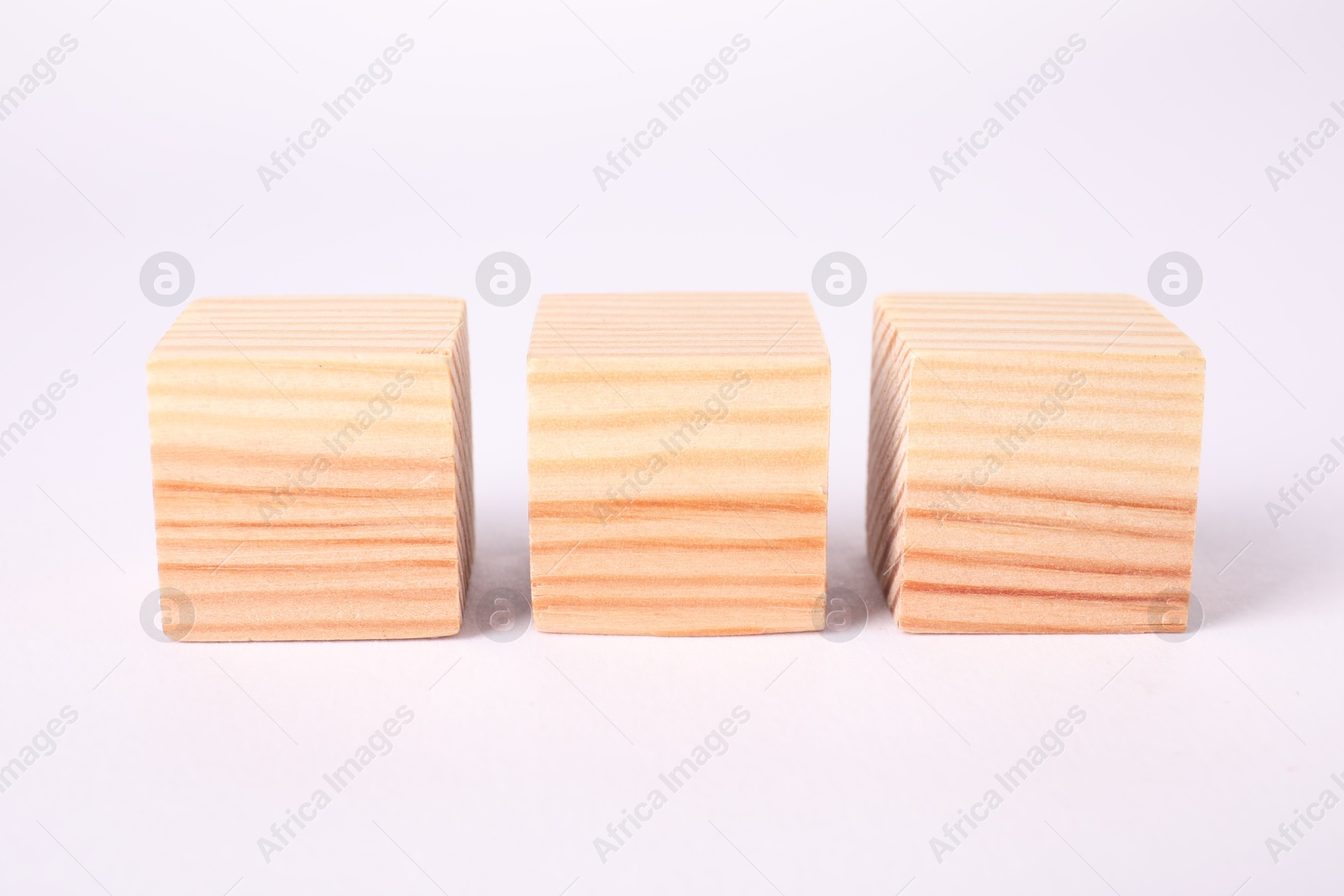 Photo of Many blank wooden cubes isolated on white