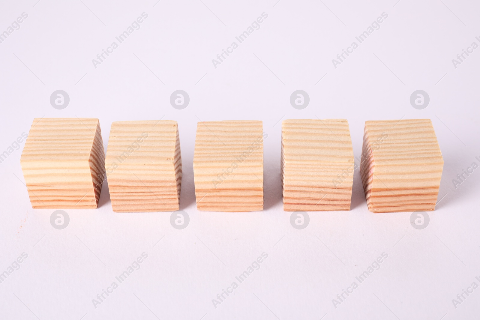 Photo of Many blank wooden cubes isolated on white