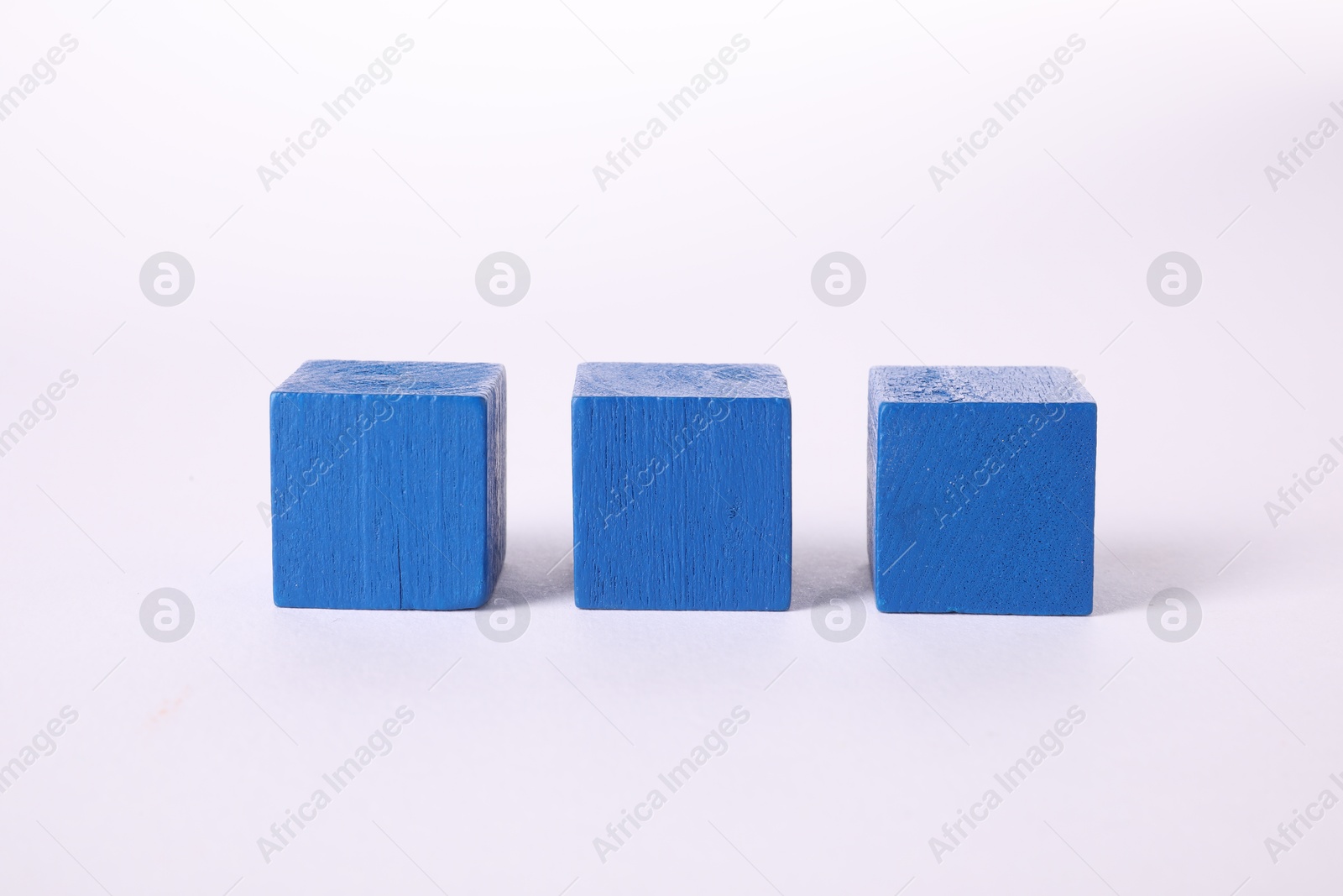 Photo of Many blue wooden cubes isolated on white