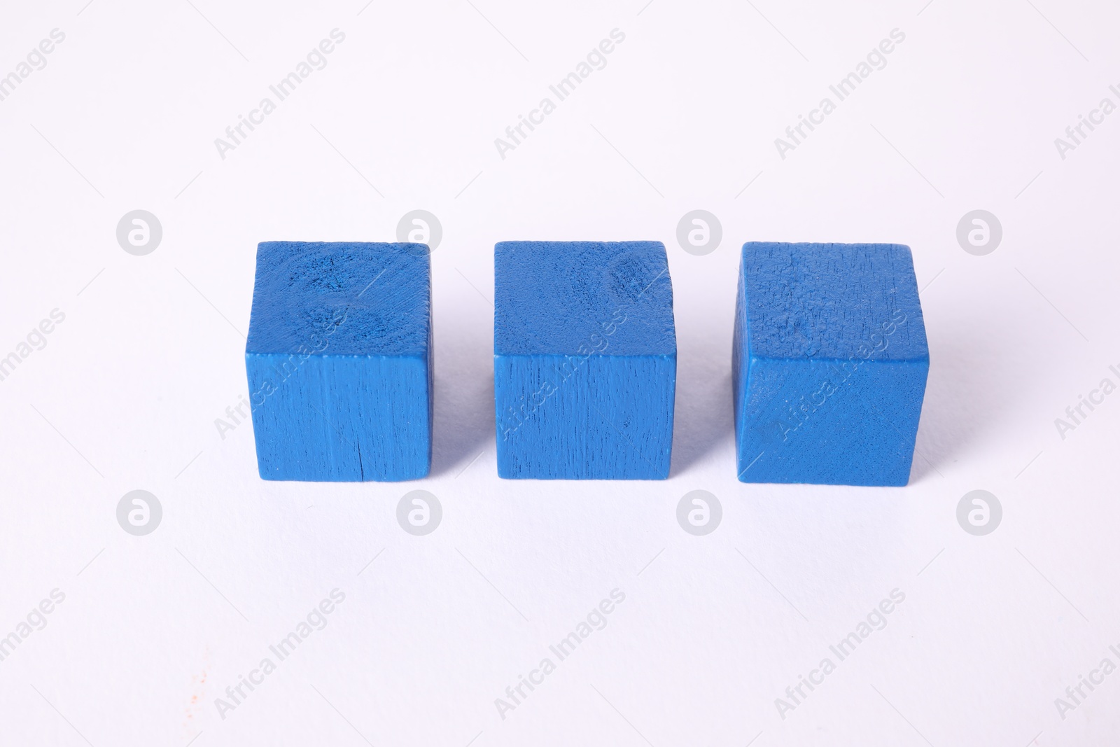 Photo of Many blue wooden cubes isolated on white