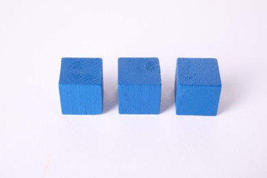 Photo of Many blue wooden cubes isolated on white