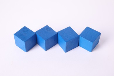 Photo of Many blue wooden cubes isolated on white