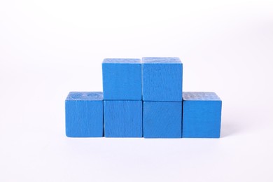 Photo of Many blue wooden cubes isolated on white