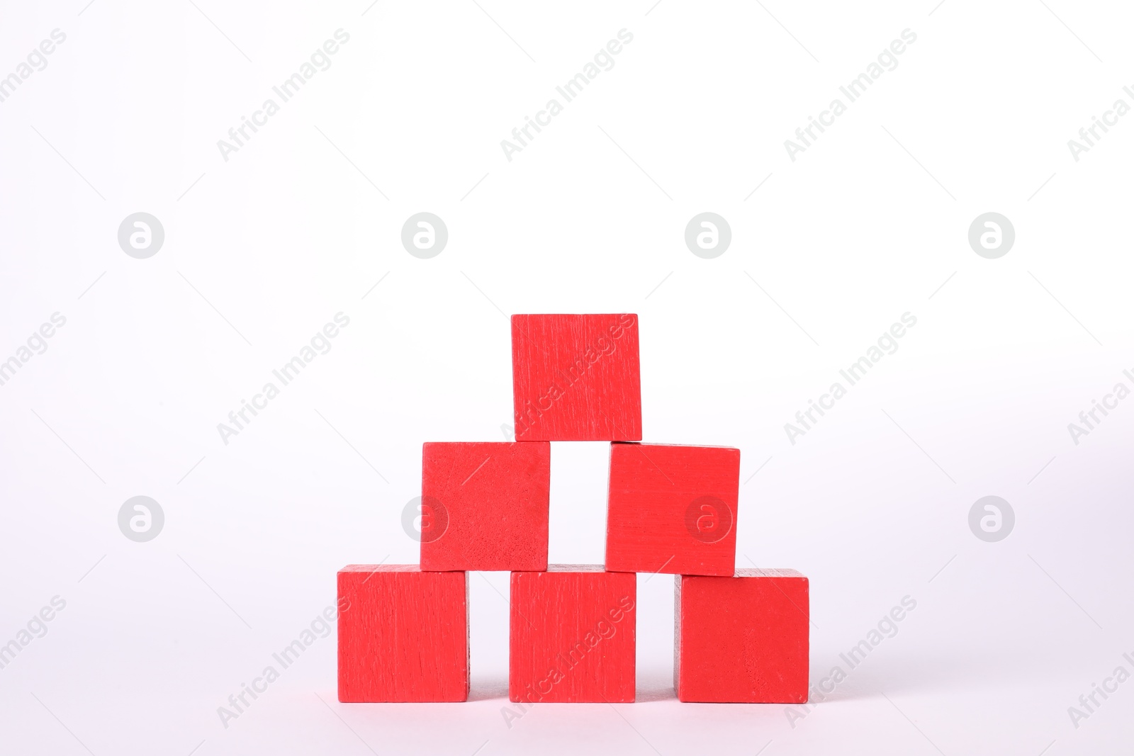 Photo of Many red wooden cubes isolated on white