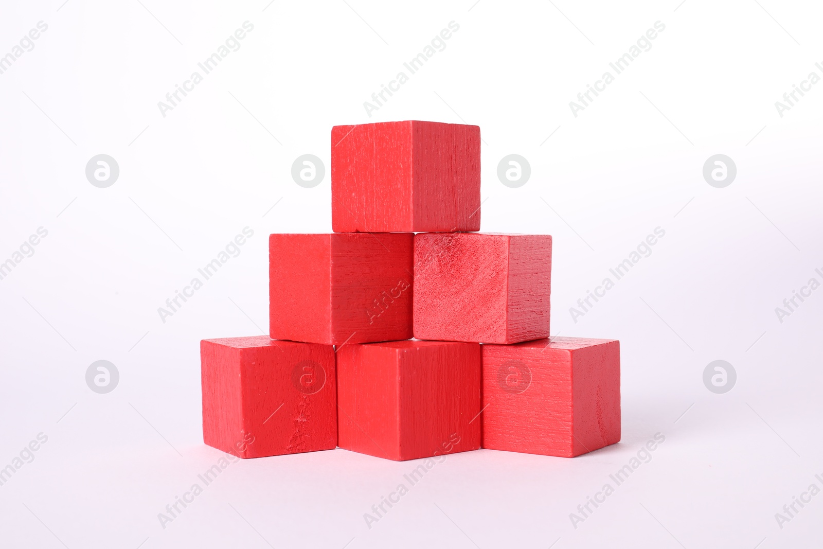 Photo of Many red wooden cubes isolated on white