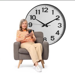 Image of Mature woman with smartphone sitting in armchair near big clock on white background