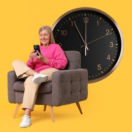 Image of Mature woman with smartphone sitting in armchair near big clock on orange background
