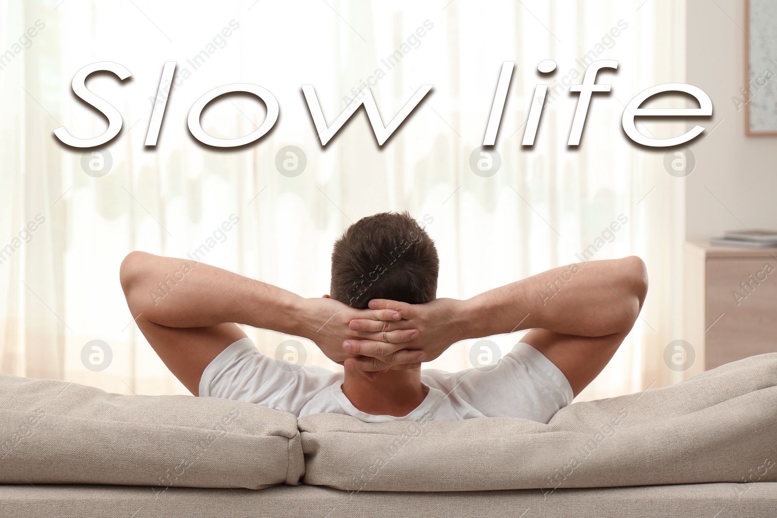 Image of Man resting on sofa at home. Slow life